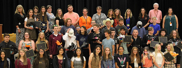 Eighth grade students group photo with awards
