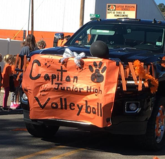 Black truck decorated with orange banner for Capitan Junior High Volleyball